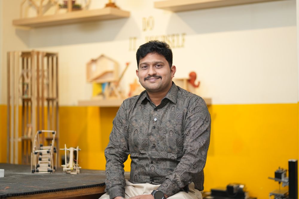 MRO‑TEK product engineer with hardware prototypes at his workbench