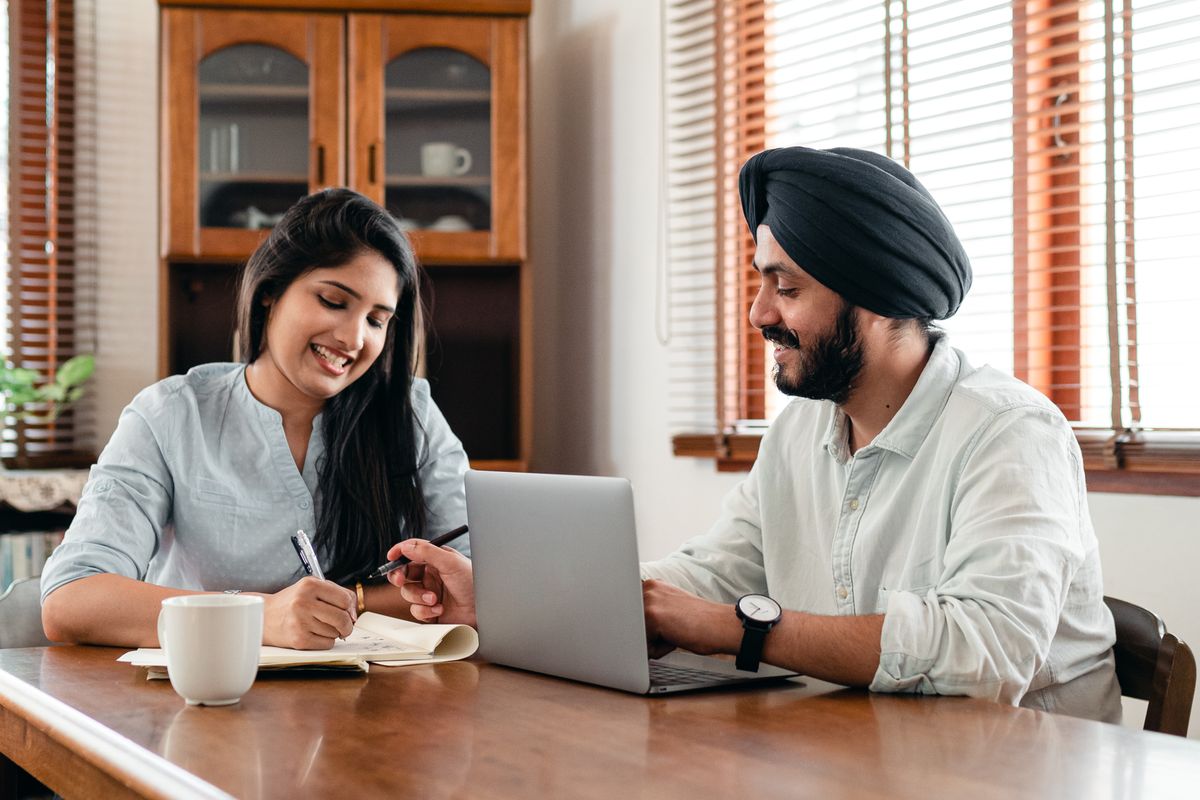 Two MRO‑TEK R&D engineers reviewing work together on a laptop