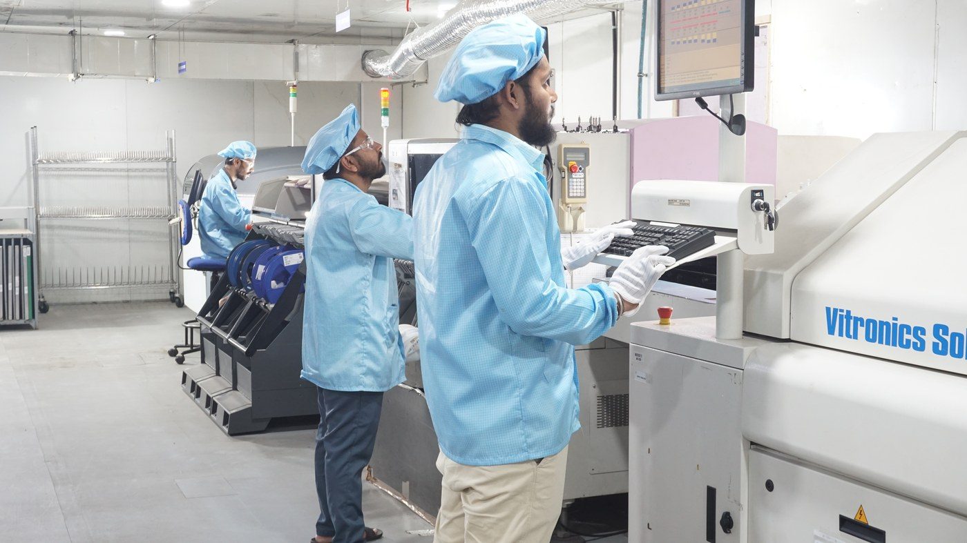 Technician programming the reflow line controller