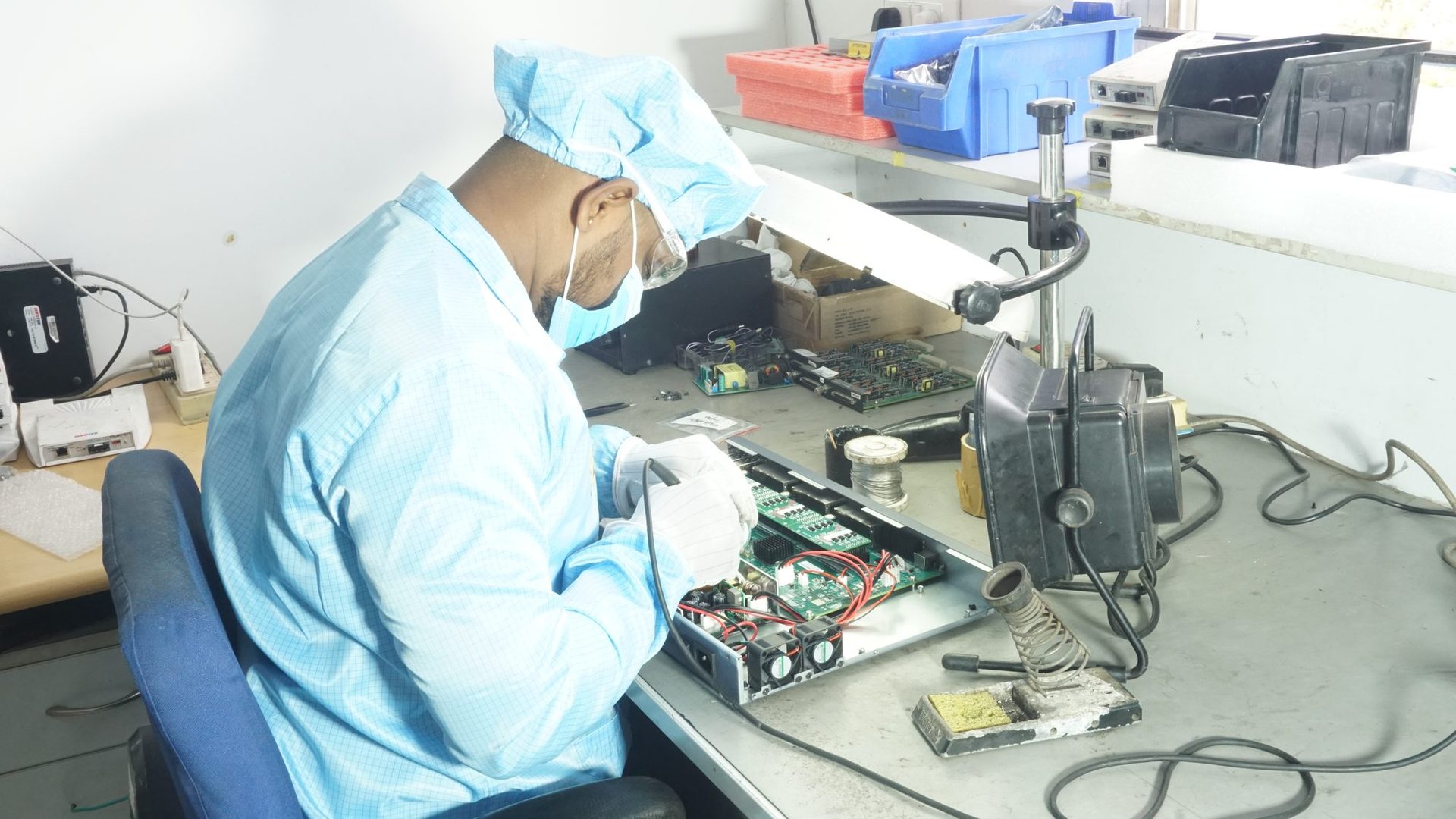 Technician performing precision repair work on a circuit board