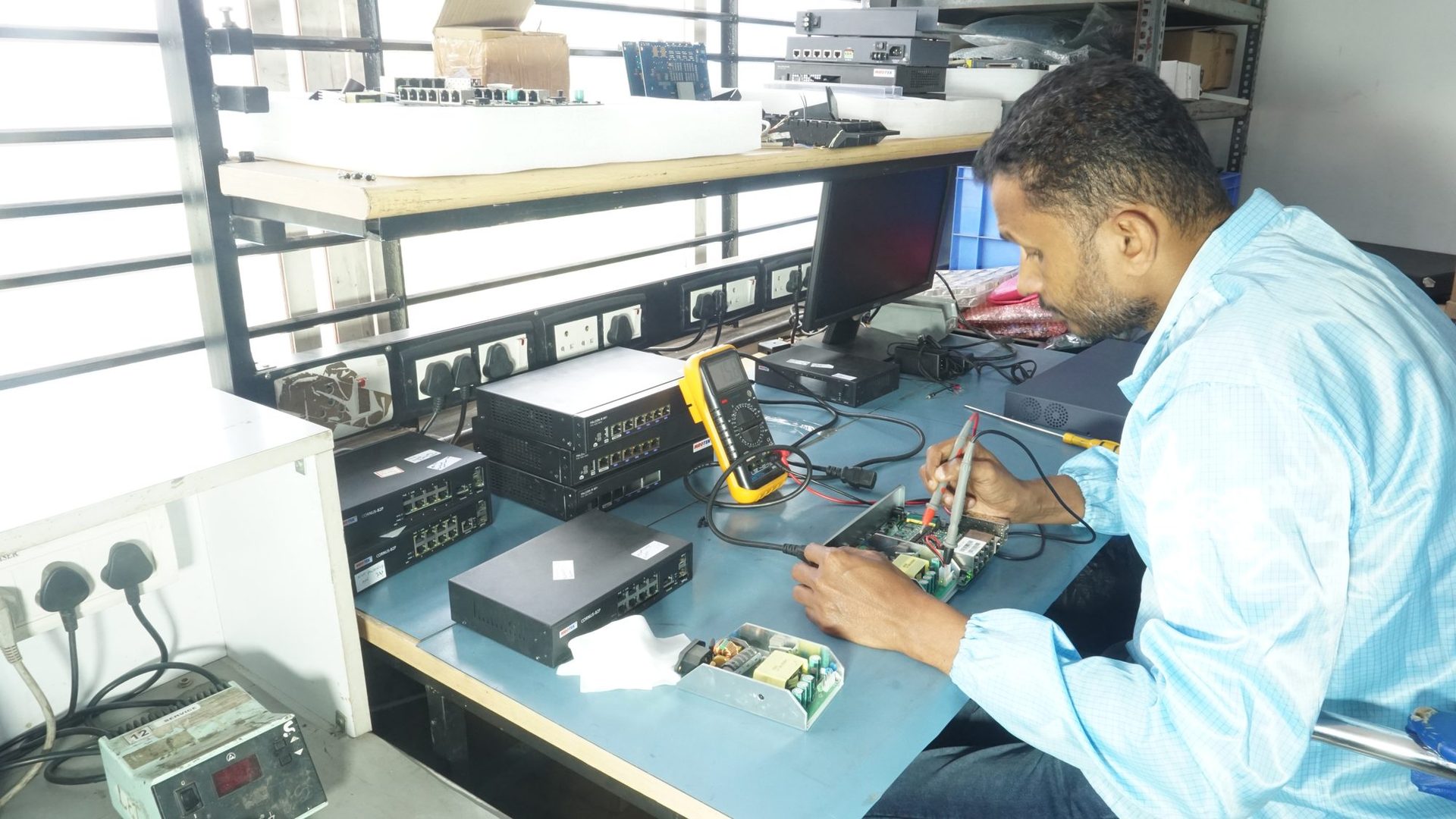 MRO‑TEK technician reworking a switch chassis on the repair bench